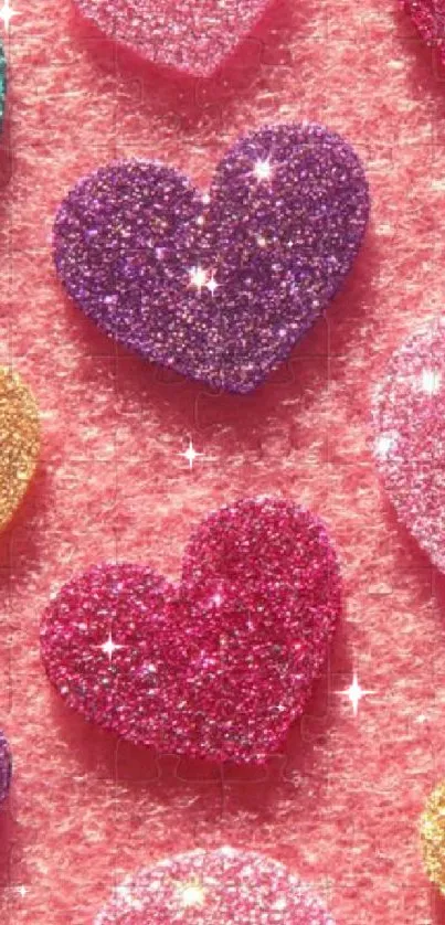 Mobile wallpaper with glitter hearts in various colors on a pink background.