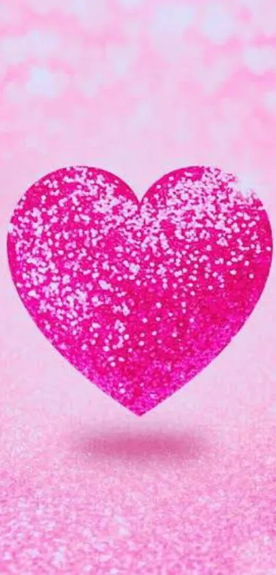 Vibrant pink glitter heart on a sparkling background.