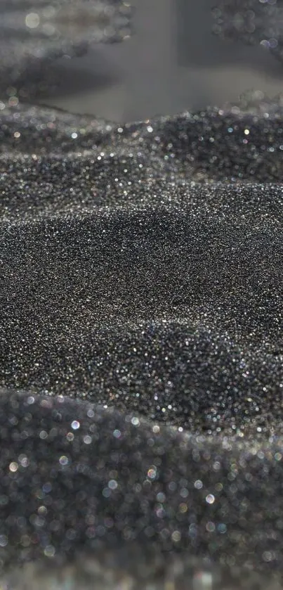 Shimmering black sand texture wallpaper for mobile.