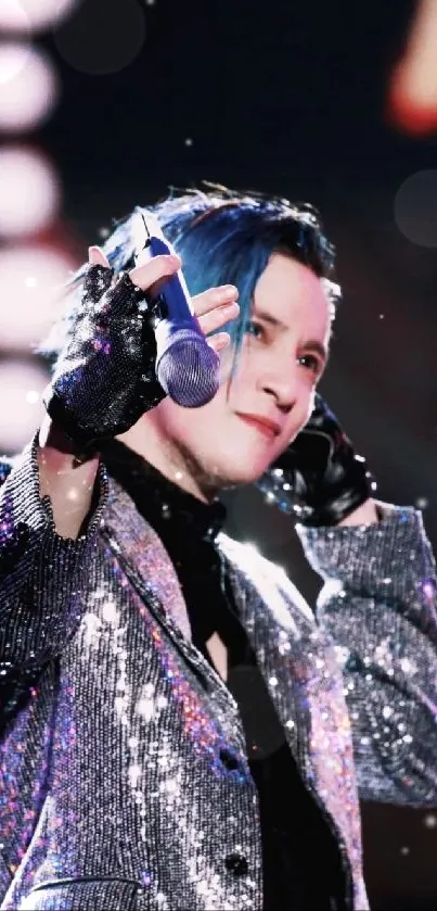 Performer on stage in a glittering sequin jacket, holding a microphone.