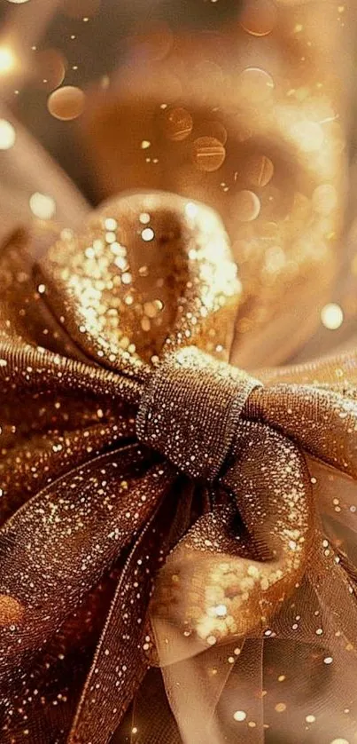 Close-up of a glittering gold bow on a festive background.