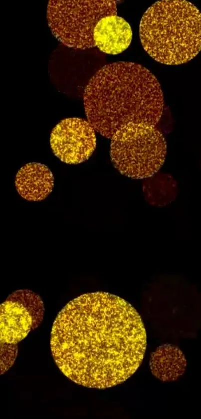 Mobile wallpaper with glittering gold circles on black background.