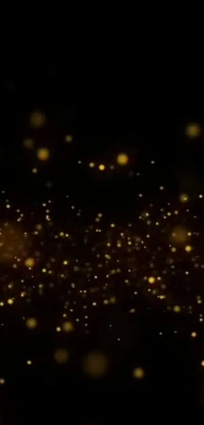 Glittering gold particles on a dark background wallpaper.