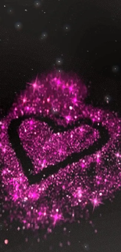 Glittering pink heart surrounded by sparkles on a dark background.