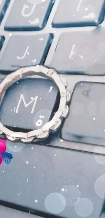 Sparkling ring on keyboard with heart accents, perfect mobile wallpaper.