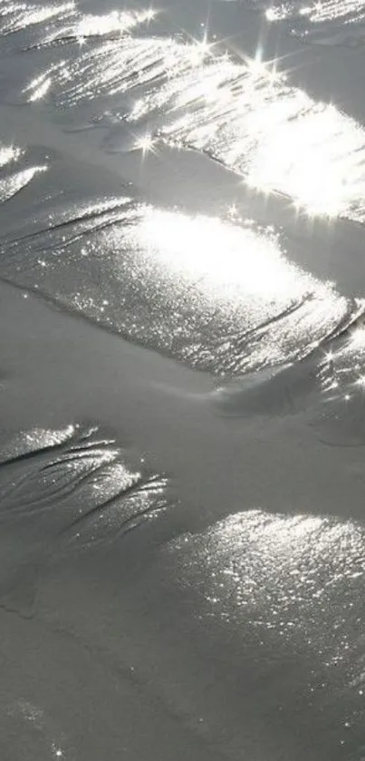 Sparkling sunlit sand with serene reflections.