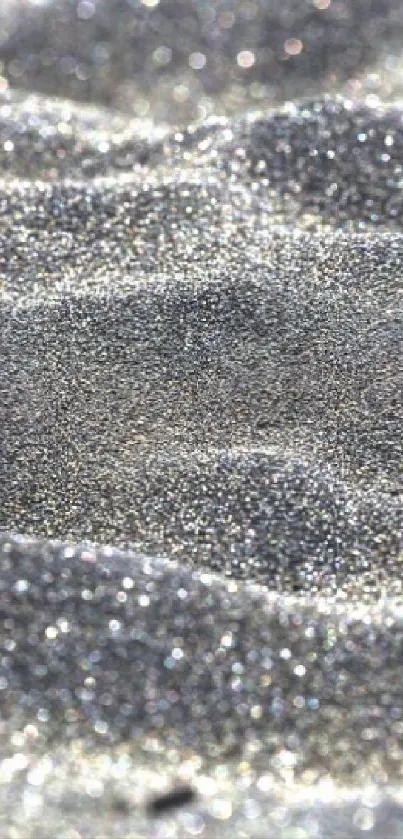 Shimmering silver sand dunes with a glittery texture.