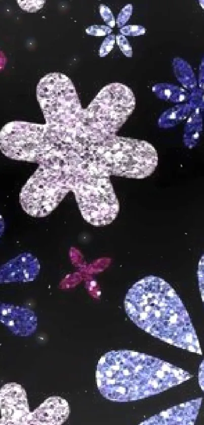 Glittery flowers in pink, blue and purple on dark background wallpaper.