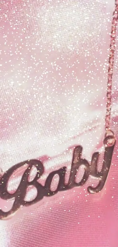 Pink glitter wallpaper with 'Baby' necklace charm.