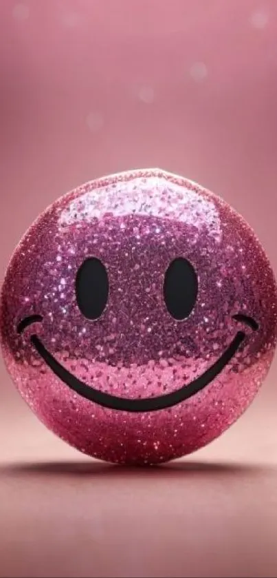 Pink glittery smiley face against pink background.