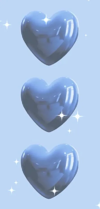 Three glossy blue hearts on light blue background wallpaper.