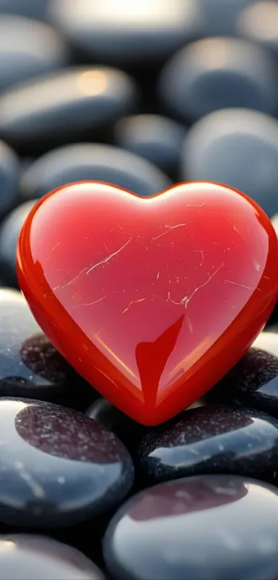 Glossy red heart on smooth black stones.
