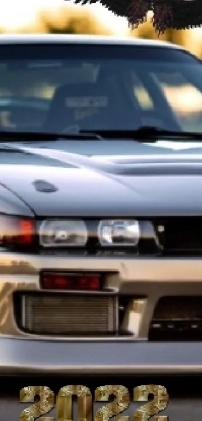 Sleek metallic sports car with 2022 emblem and eagle above.