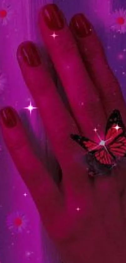 A hand with a butterfly ring on a glowing pink background with flowers.