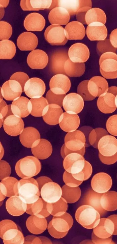 Mobile wallpaper with glowing orange bokeh lights.