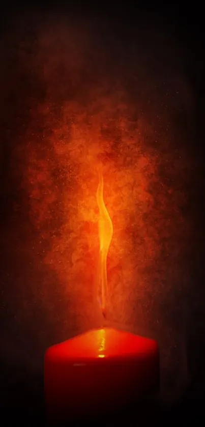 A glowing candle with a vibrant flame against a dark, smoky background.