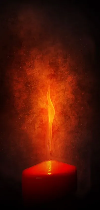 Glowing red candle flame on dark background wallpaper.