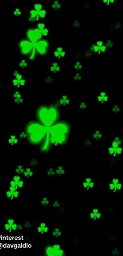 Glowing green clovers on a dark background wallpaper.