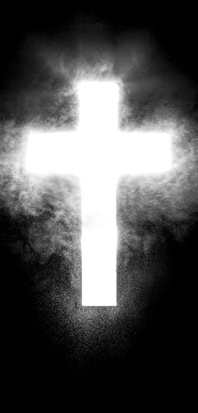 Glowing white cross with mist on black background.