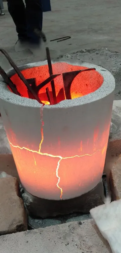 Glowing crucible with orange light in an industrial setting on wallpaper.