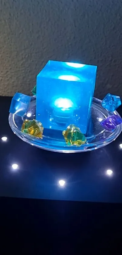 A glowing blue cube with colorful gem accents on a dark background.