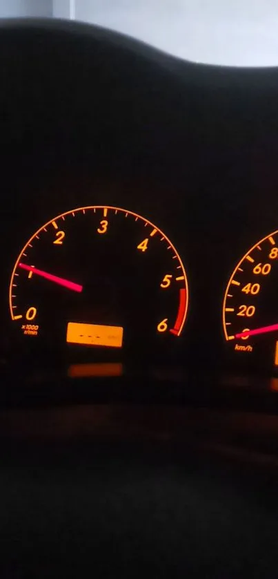 Glowing car dashboard with illuminated gauges.