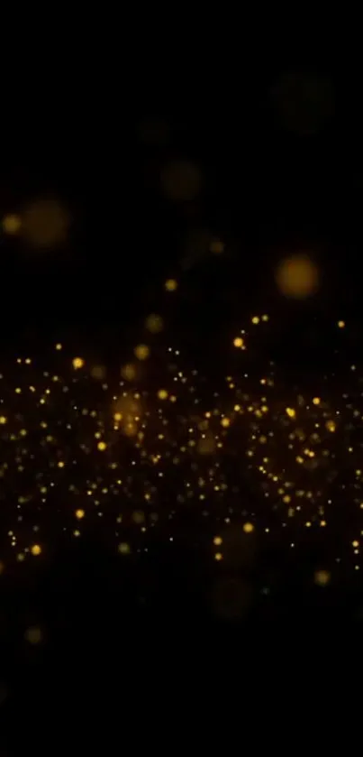 Mobile wallpaper with gold particles on a black background.