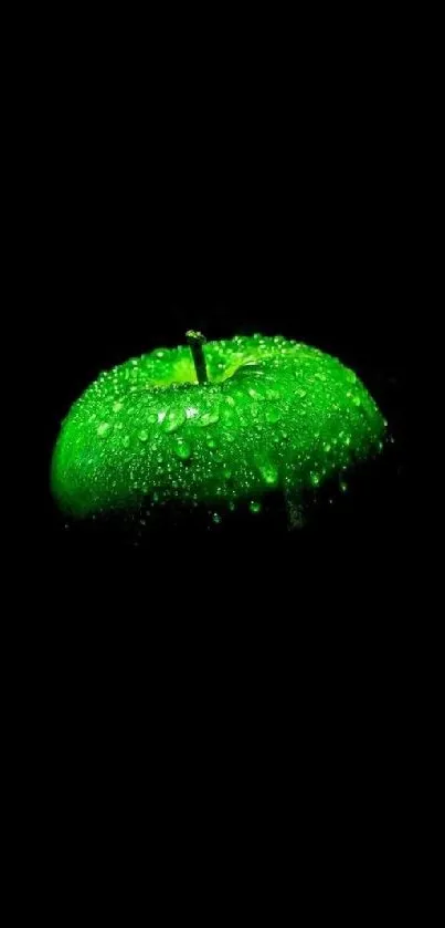 Glowing green apple with water droplets on a dark background.