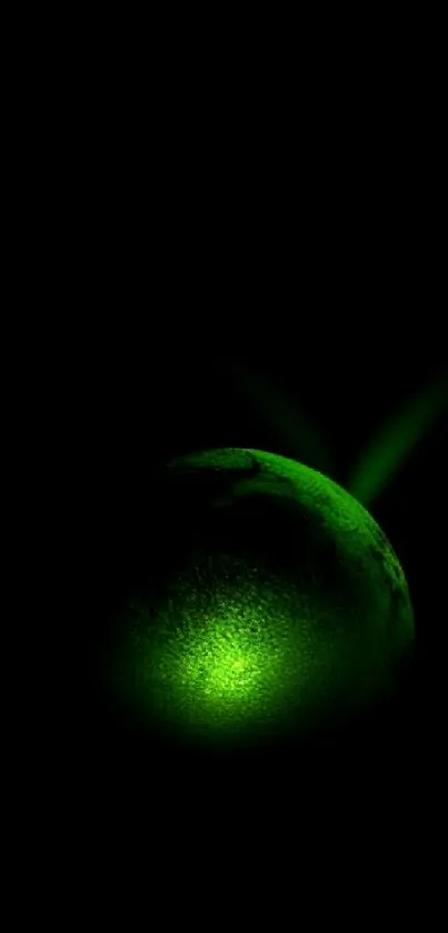 Glowing green orb with dark background wallpaper.