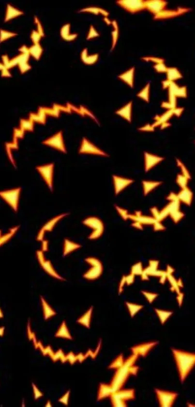 Glowing jack-o'-lantern faces on dark Halloween wallpaper.