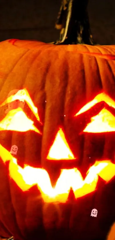 Glowing Halloween pumpkin with carved spooky face on dark background.