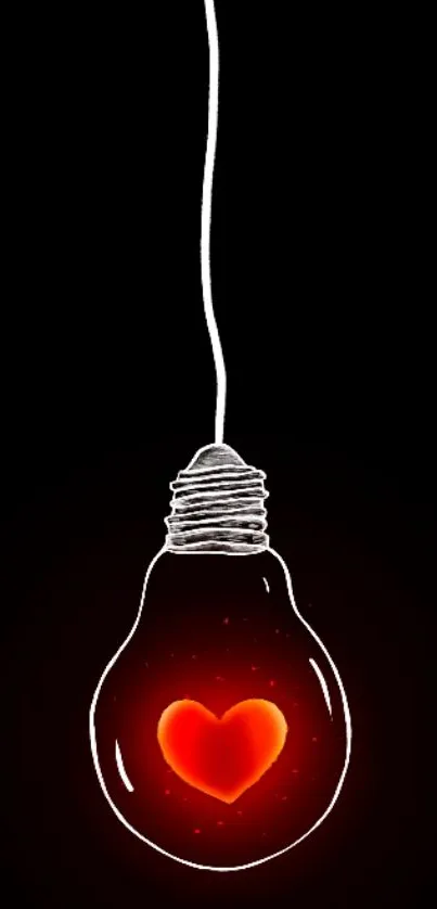 Heart glowing inside light bulb on dark background.