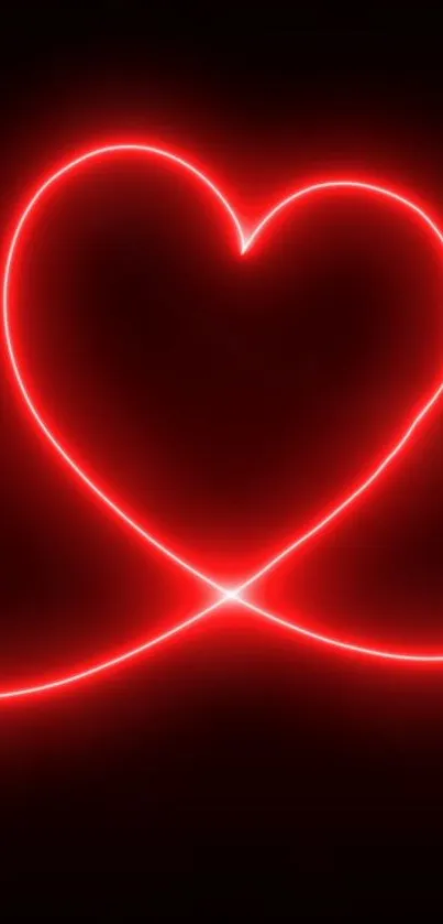 Vibrant red neon heart glowing on dark background.