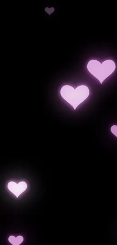 Wallpaper with glowing pink hearts on a dark background.