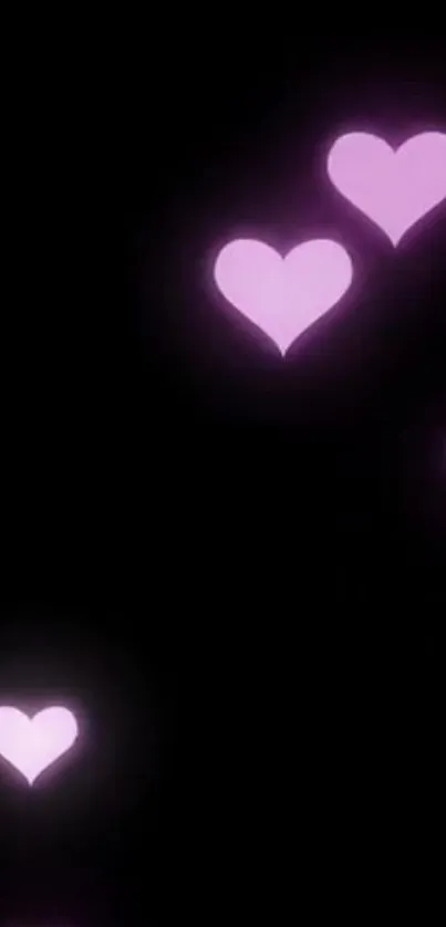 Glowing pink hearts on a black background.