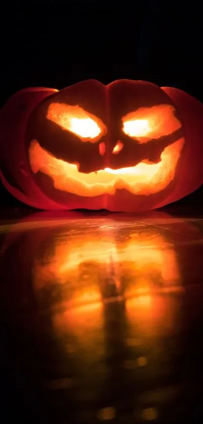 Spooky glowing Jack-o'-Lantern reflecting light.