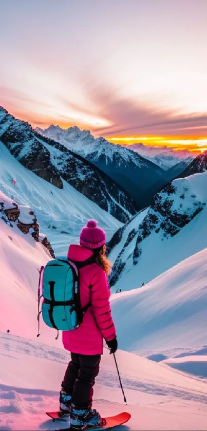 A skier on a mountain at sunset with vibrant pink hues and snow-capped peaks.