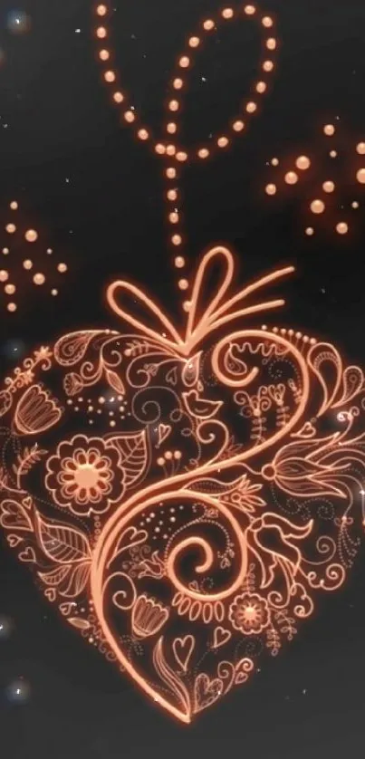 Ornate heart design in glowing orange on black background.