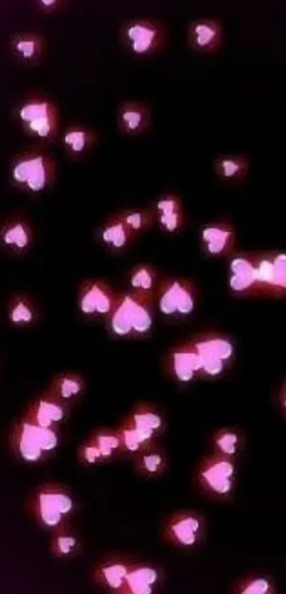 Glow pink hearts on black background wallpaper.