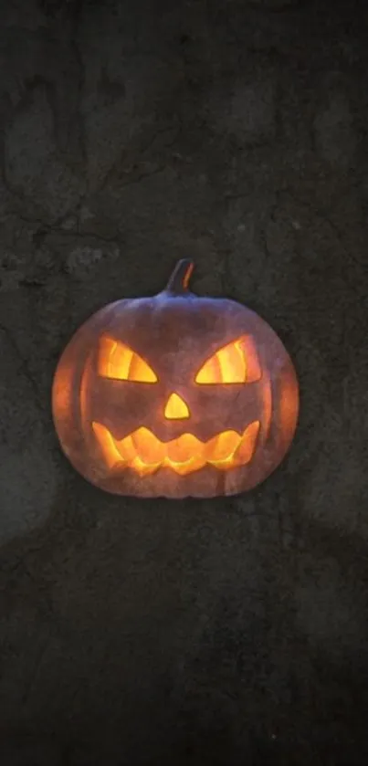 A glowing jack-o'-lantern on a dark Halloween-themed wallpaper.