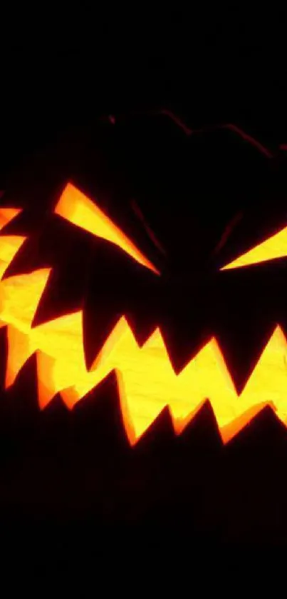 Glowing jack-o'-lantern on a dark background.