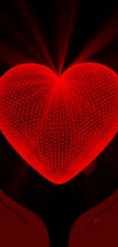 Glowing red heart held between two hands in dark background.