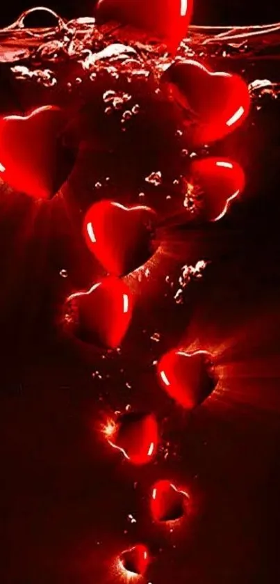 Glowing red hearts submerged in water, creating a romantic and vibrant mobile wallpaper.