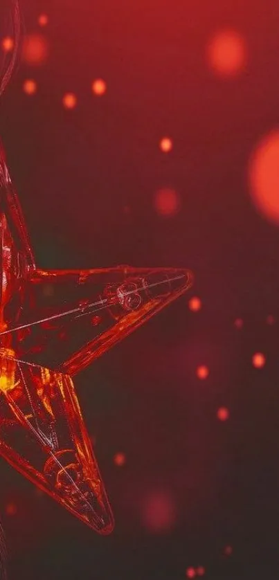 Glowing red star with bokeh effect on dark background.