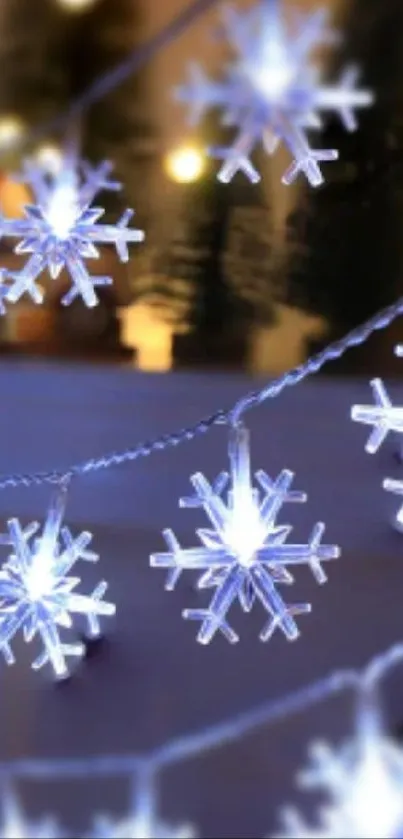 Glowing snowflake string lights on a cozy winter evening background.