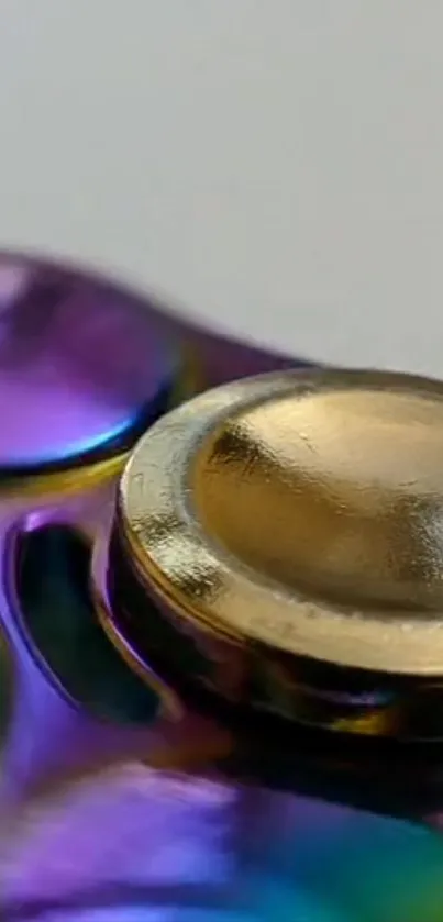 Close-up of a metallic spinner with gold and purple colors.