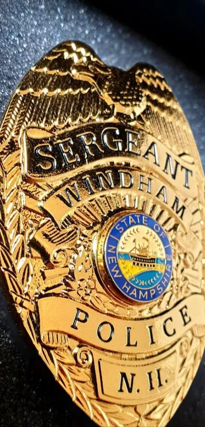 Close-up of a gold police badge with intricate design elements.