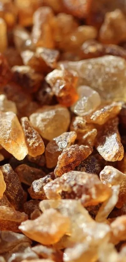 Mobile wallpaper featuring close-up of amber-colored stones in natural light.