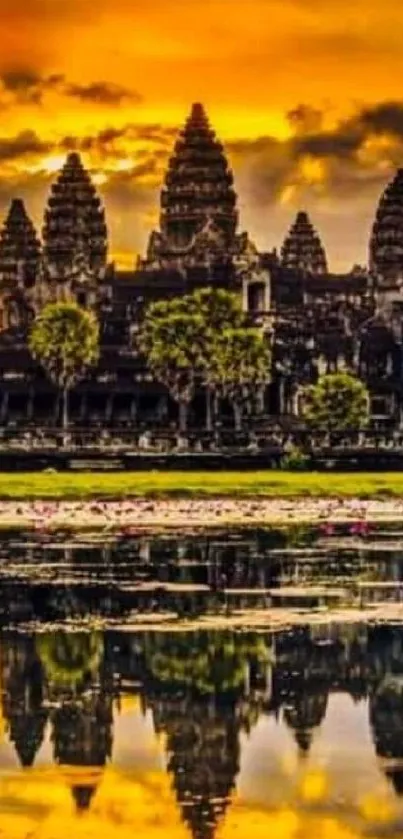 Angkor Wat at sunset reflected in water with golden sky.