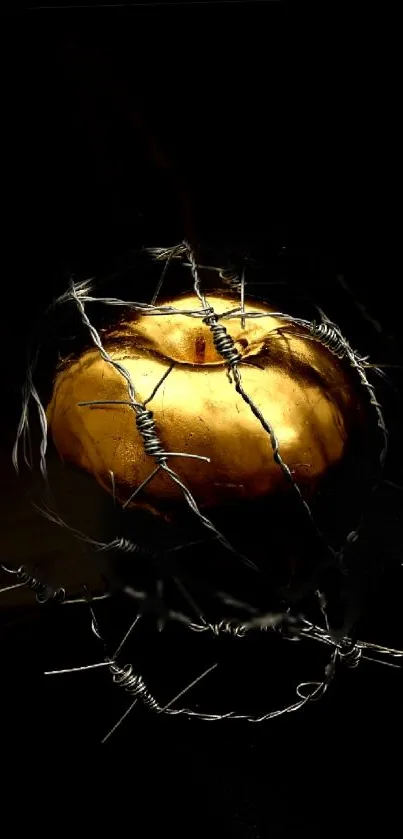 Golden apple wrapped in barbed wire on a dark background.